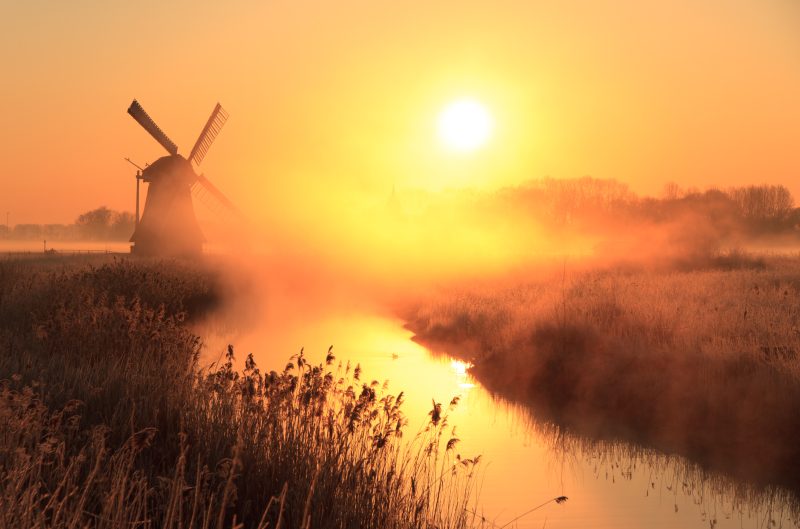 Dutch,Sunrise,With,Traditional,Windmill,And,A,Canal,In,The